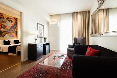 a living room with a couch and a bed at Best Western Plus Embassy Hotel in Athens