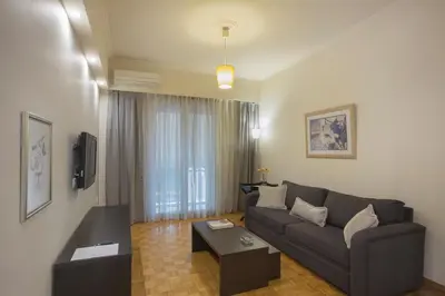 a living room with a couch and a table at Apartment at Koukaki, 150m from the metro by YHA in Athens