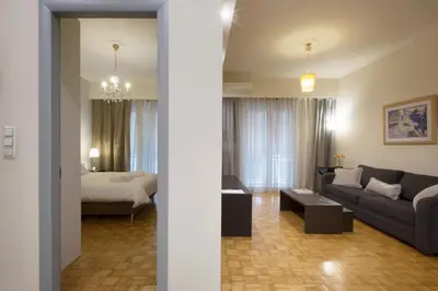 a living room with a couch and a bedroom at Apartment at Koukaki, 150m from the metro by YHA in Athens