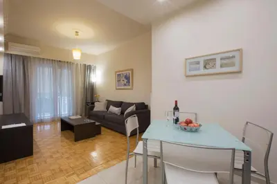 a living room with a couch and a table at Apartment at Koukaki, 150m from the metro by YHA in Athens