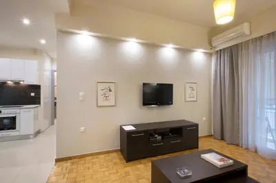 a living room with a flat screen tv on the wall at Apartment at Koukaki, 150m from the metro by YHA in Athens