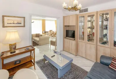 a living room with a couch and a table at Nice Sea View Elegant Apartment in Athens