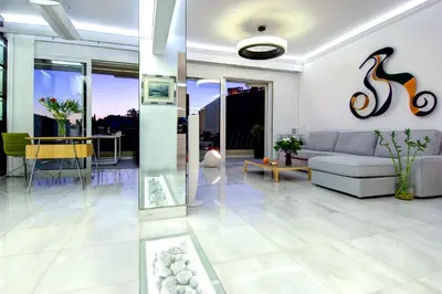 a living room with a couch and a table at Frixos Acropolis Luxury Apartment in Athens