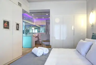 a bedroom with a bed with two pillows on it at Frixos Acropolis Luxury Apartment in Athens