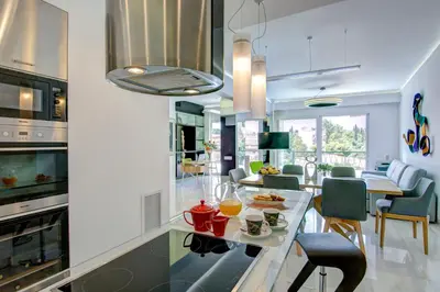 a kitchen and living room with a table with food on it at Frixos Acropolis Luxury Apartment in Athens