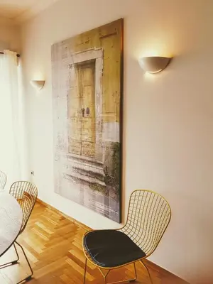 a dining room with two chairs and a painting on the wall at Park at Home Apartment in Athens