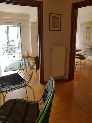 a living room with chairs and a table at Park at Home Apartment in Athens