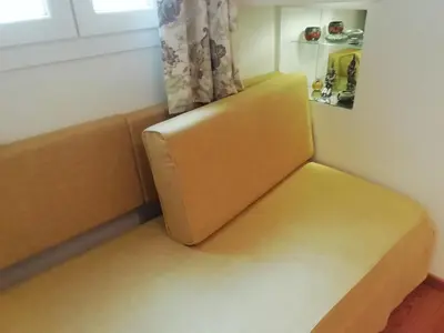 a yellow bench in a room with a window at Be My Guest Apartment in Athens