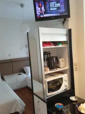 a refrigerator with its door open with a microwave inside at Be My Guest Apartment in Athens