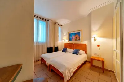 a hotel room with a bed and a window at Hapimag Apartments Athens in Athens
