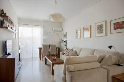 a living room with a couch and a table at Varkiza Apartment in Varkiza