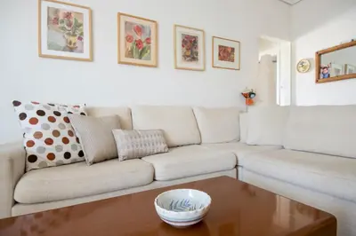 a living room with a couch and a coffee table at Varkiza Apartment in Varkiza