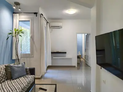 a living room with a couch and a television at KYMA Apartments - Athens Acropolis 5 in Athens