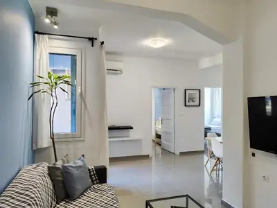 a living room with a couch and a tv at KYMA Apartments - Athens Acropolis 5 in Athens