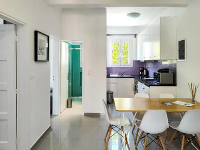 a kitchen and dining room with a table and chairs at KYMA Apartments - Athens Acropolis 5 in Athens