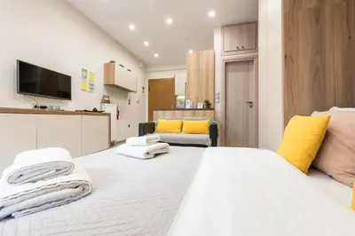 a bedroom with a large white bed with towels on it at Athens Heart Design Studio in Athens
