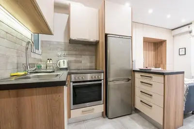 a kitchen with a sink and a refrigerator at Athens Heart Design Studio in Athens