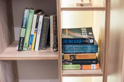 a book shelf filled with lots of books at Athens Heart Design Studio in Athens