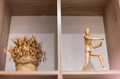 a wooden mannequin on a shelf next to a plant at Athens Heart Design Studio in Athens