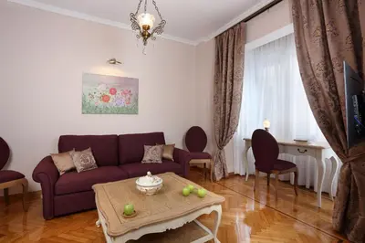 a living room with a purple couch and a table at V1935 Luxurious Apartments in Athens