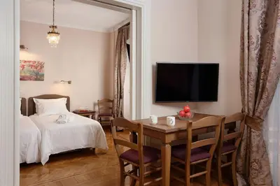 a bedroom with a table and a bed and a television at V1935 Luxurious Apartments in Athens