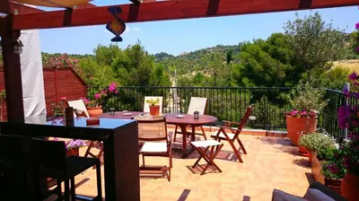 a patio with a table and chairs on a balcony at Elegant apartment in Acropolis with roof garden in Athens