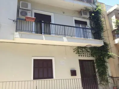 an apartment building with a balcony with an air conditioner at Elegant apartment in Acropolis with roof garden in Athens
