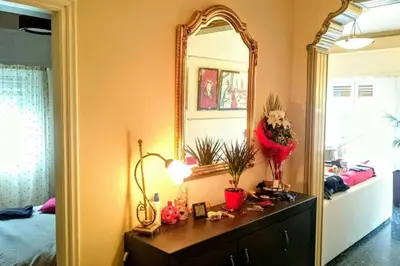 a room with a mirror and a dresser and a bed at Elegant apartment in Acropolis with roof garden in Athens