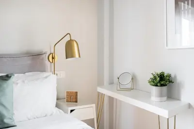 a bedroom with a bed and a table with a plant at Zeus Temple view 2BD Apartment by UPSTREET in Athens