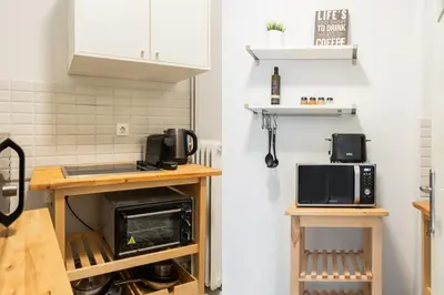 a kitchen with white cabinets and a microwave oven at Zeus Temple view 2BD Apartment by UPSTREET in Athens