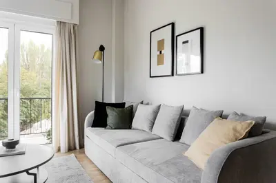 a living room with a gray couch and a table at Zeus Temple view 2BD Apartment by UPSTREET in Athens