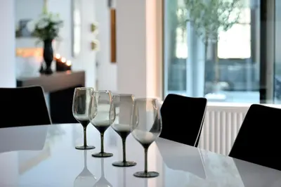 four wine glasses sitting on top of a table at ALDIS MANSION by K&K in Athens