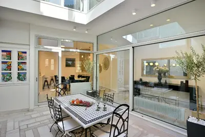 a dining room with a table and chairs and a room with a dining room at ALDIS MANSION by K&K in Athens