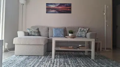 a living room with a couch and a table at DaMa Blue in Saronida