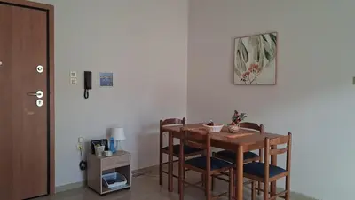 a dining room with a table and chairs at DaMa Blue in Saronida