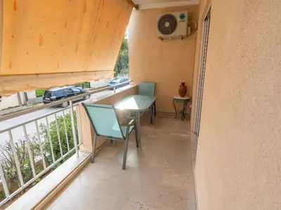 a balcony with a table and chairs on a balcony at DaMa Blue in Saronida