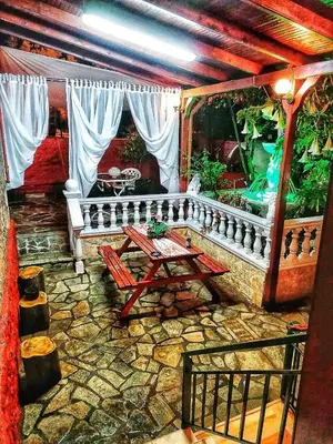 a patio with a table and a fish tank at Stone house under Acropolis in Athens