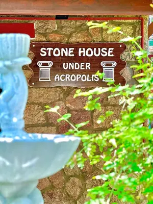 a sign for a stone house under apopolis at Stone house under Acropolis in Athens