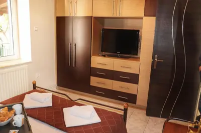 a kitchen with a large refrigerator and a table with towels at Stone house under Acropolis in Athens