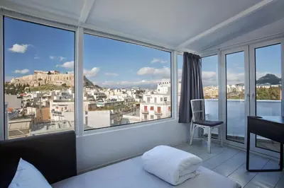 a room with a bed and a desk and windows at Bright Apartment with Stunning Acropolis Views! SG5 in Athens