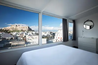 a bedroom with a white bed and a large window at Bright Apartment with Stunning Acropolis Views! SG5 in Athens