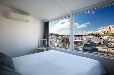 a bedroom with a white bed and a large window at Bright Apartment with Stunning Acropolis Views! SG5 in Athens