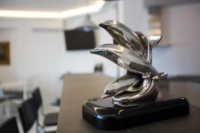 a metal statue of a bird on a table at Bright Apartment with Stunning Acropolis Views! SG5 in Athens