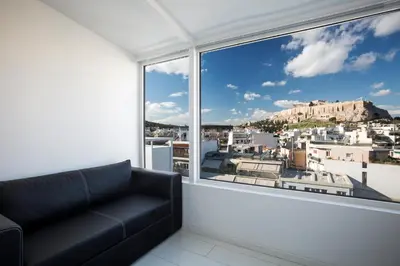 a black couch in a room with a large window at Bright Apartment with Stunning Acropolis Views! SG5 in Athens
