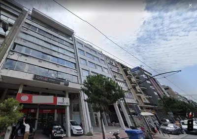 a tall building on a city street with a cloudy at Bright Apartment with Stunning Acropolis Views! SG5 in Athens
