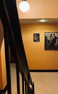 a hallway with a staircase and a picture on the wall at Alfa Hotel in Piraeus