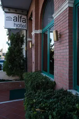 a hotel sign on the side of a brick building at Alfa Hotel in Piraeus
