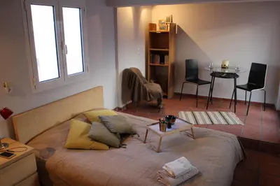 a bedroom with a bed and a table and chairs at Roof Top Studio in Athens