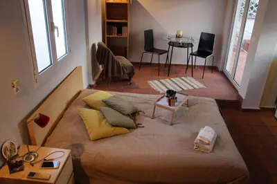 a bedroom with a bed and a table and chairs at Roof Top Studio in Athens
