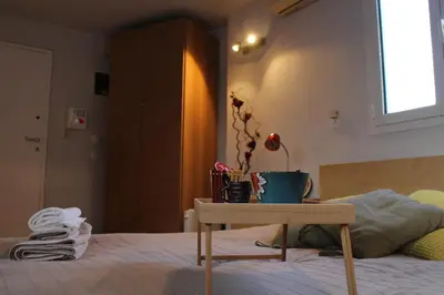 a room with a bed with a table on it at Roof Top Studio in Athens